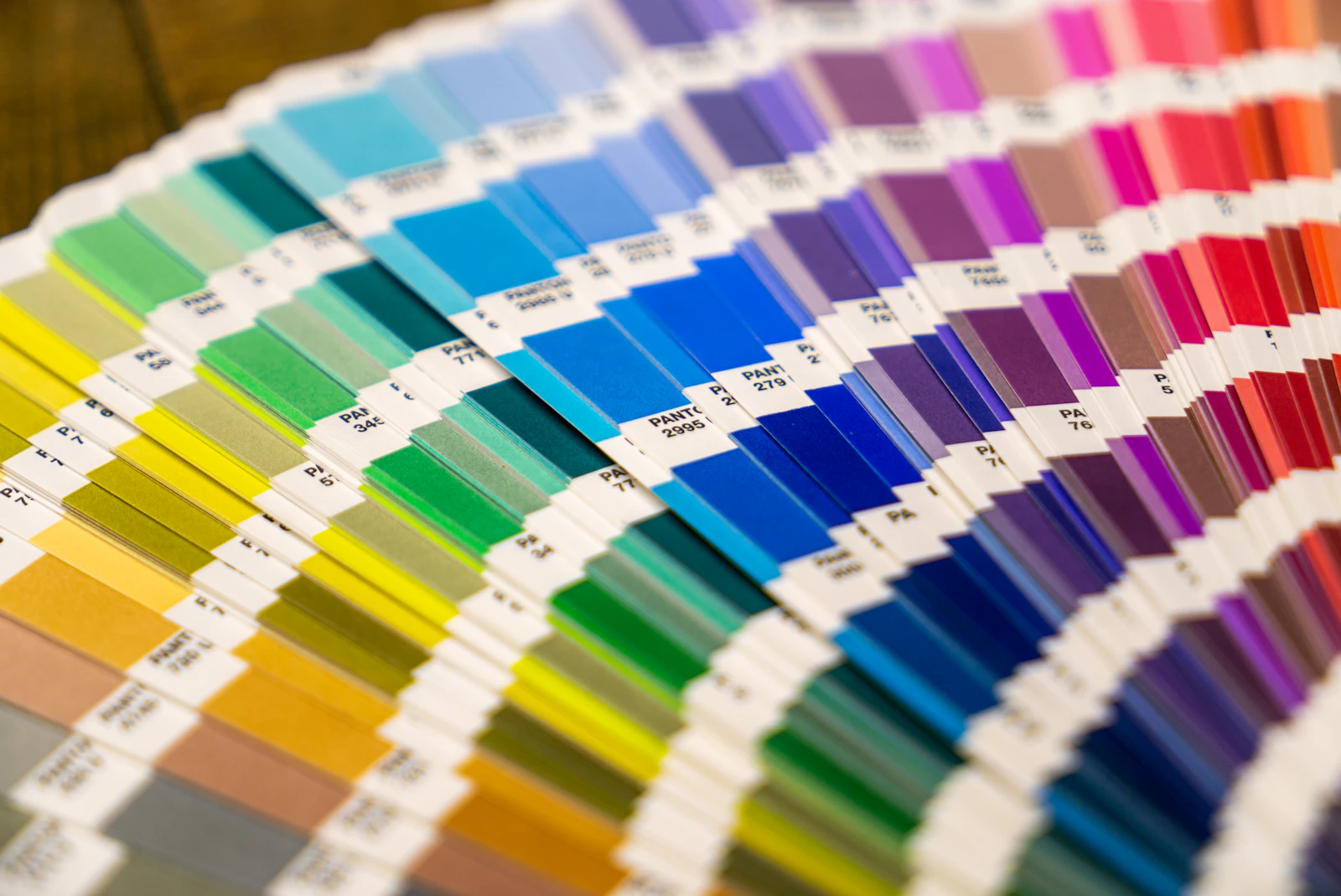 Rainbow fan deck of paint colour swatches spread open