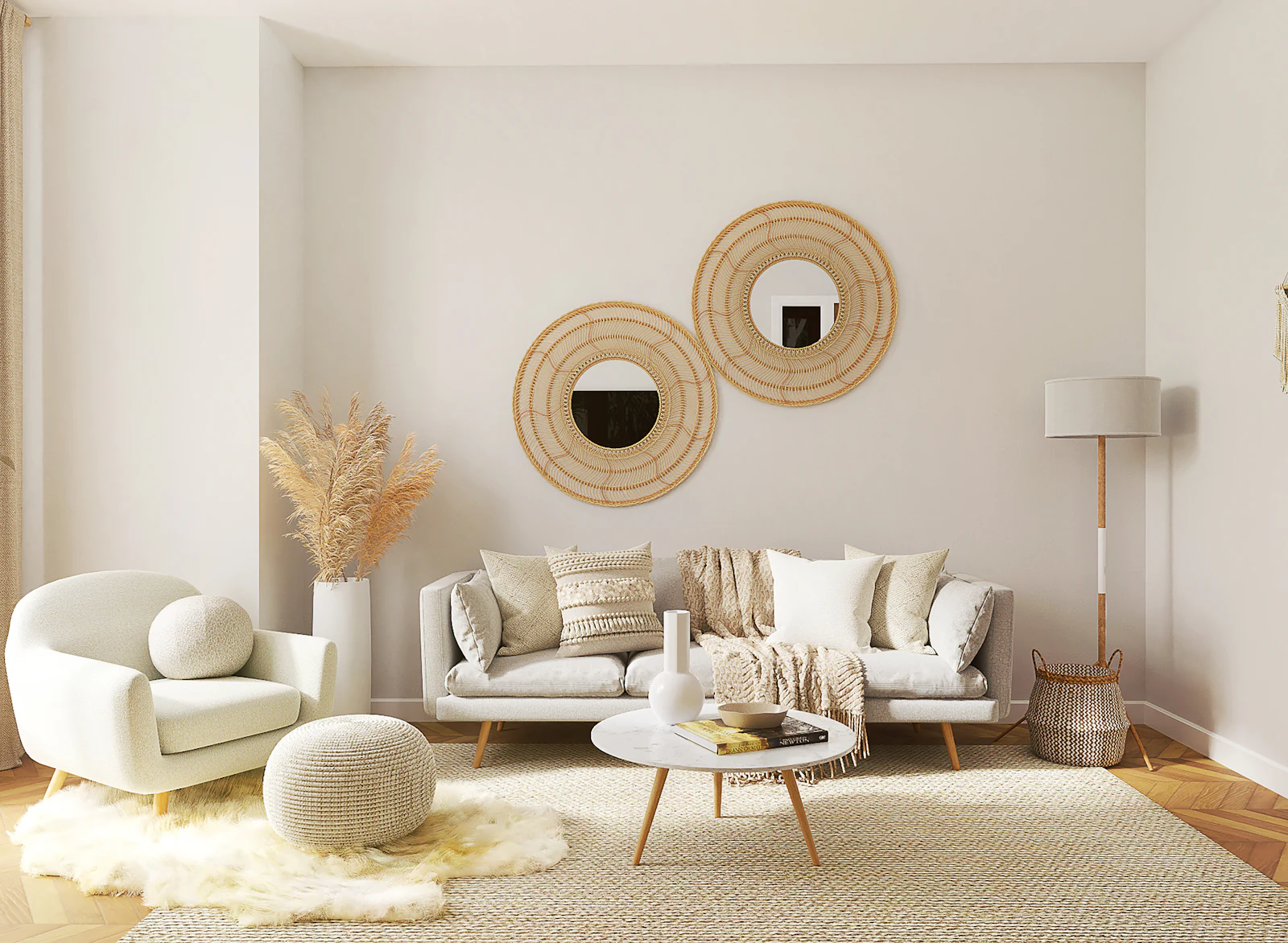 Cream sofa with round rattan mirrors, dried grasses and a boucle armchair