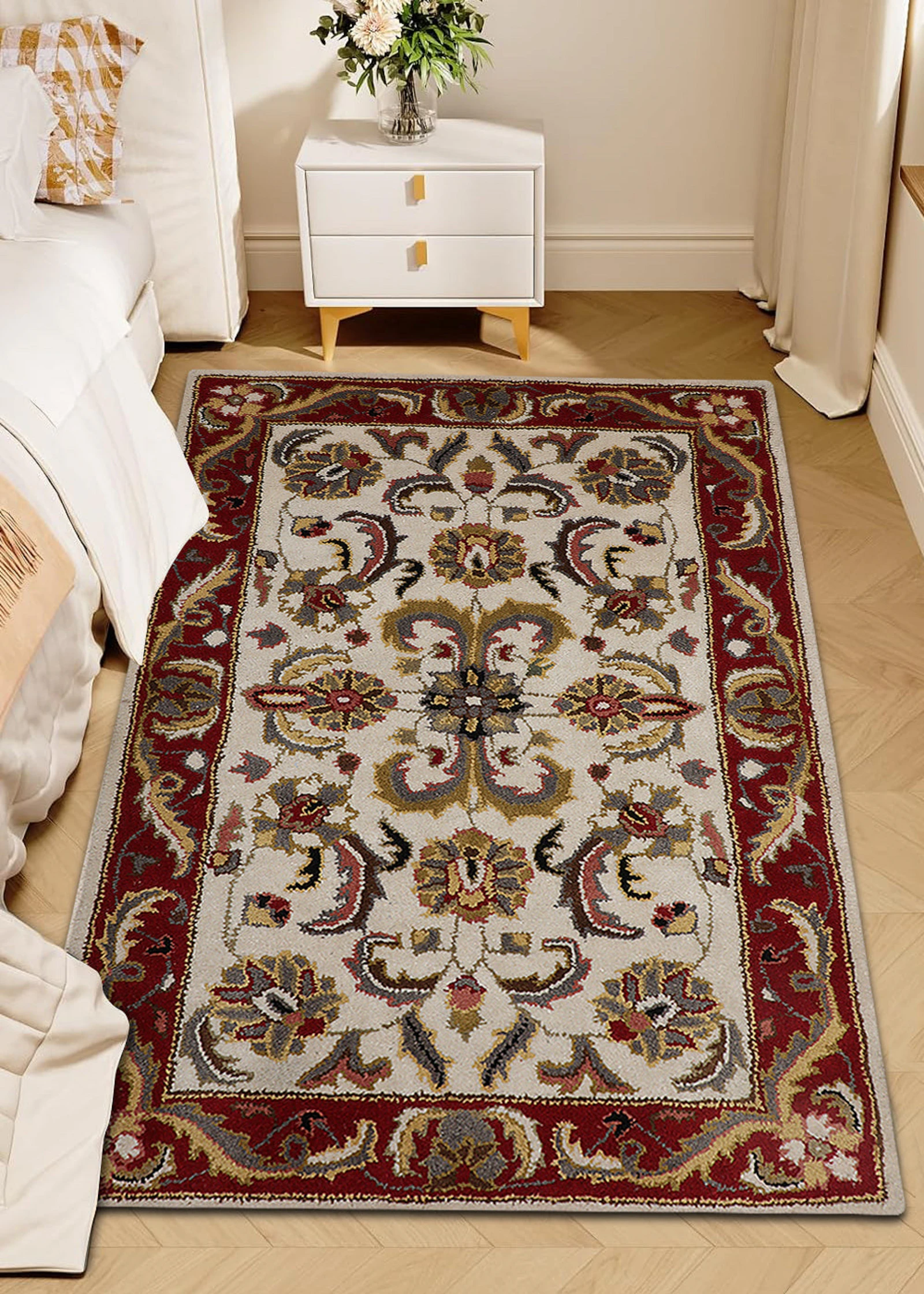 Red and cream traditional patterned rug on a wooden floor